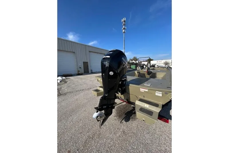 Slide: The Image of 2021 Tracker Grizzly 2072 CC boat with outboard motor in a parking lot. - 10