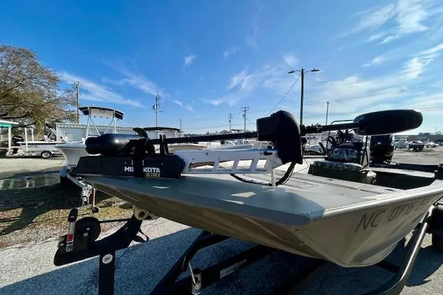Slide: The Image of 2021 Tracker Grizzly 2072 CC boat on trailer under clear blue sky. - 2