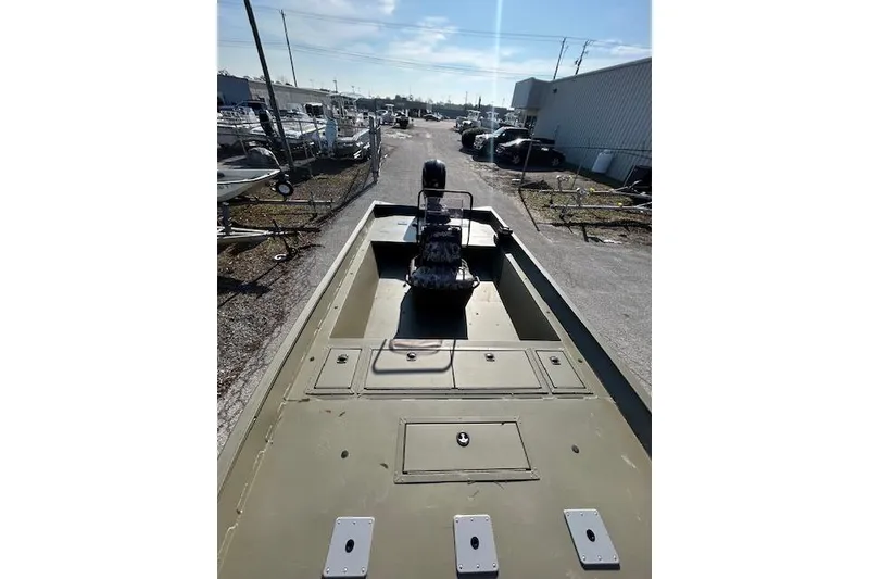 Slide: The Image of 2021 Tracker Grizzly 2072 CC boat parked outdoors in a marina setting. - 4