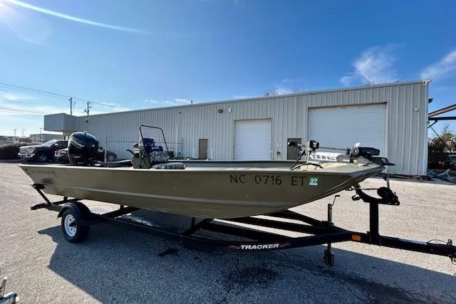 Slide: The Image of 2021 Tracker Grizzly 2072 CC boat on trailer, parked outside industrial building. - 8