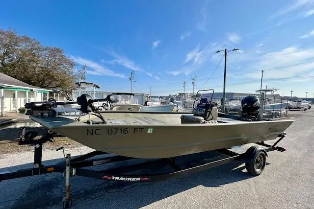 Slide: The Image of 2021 Tracker Grizzly 2072 CC boat on trailer in marina setting. - 9