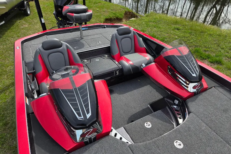 Slide: The Image of 2020 Ranger Z520C Cup-Equipped boat interior with red and black seating, near a lake. - 9