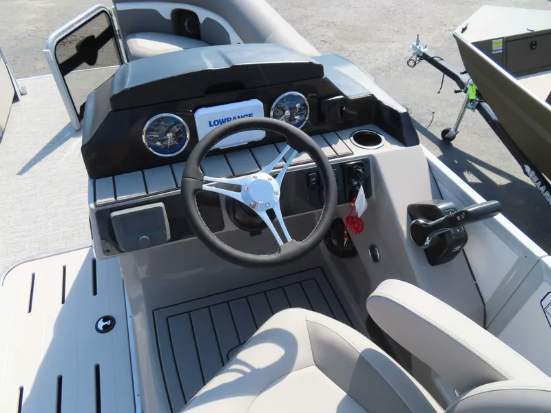 Slide: The Image of Premier SUNSATION 210 RL 2026 helm with steering wheel and gauges. - 13