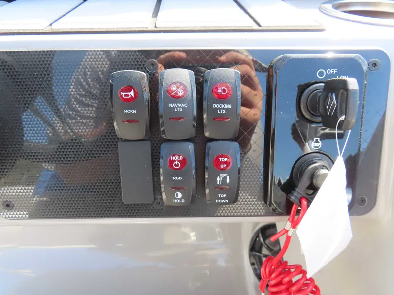 Slide: The Image of Control panel of Premier SUNSATION 210 RL 2026 with switches and ignition key. - 15