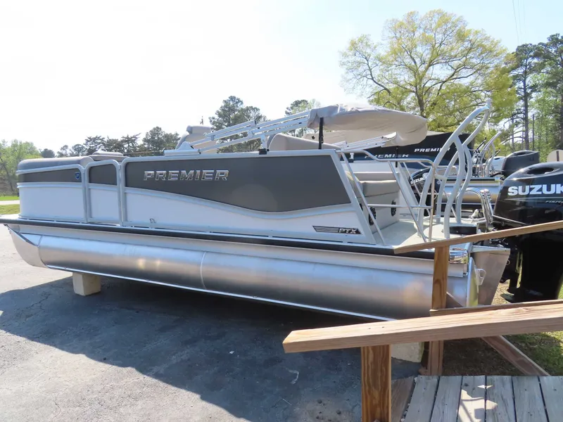 Slide: The Image of 2026 Premier SUNSATION 210 RL pontoon boat parked outdoors. - 25