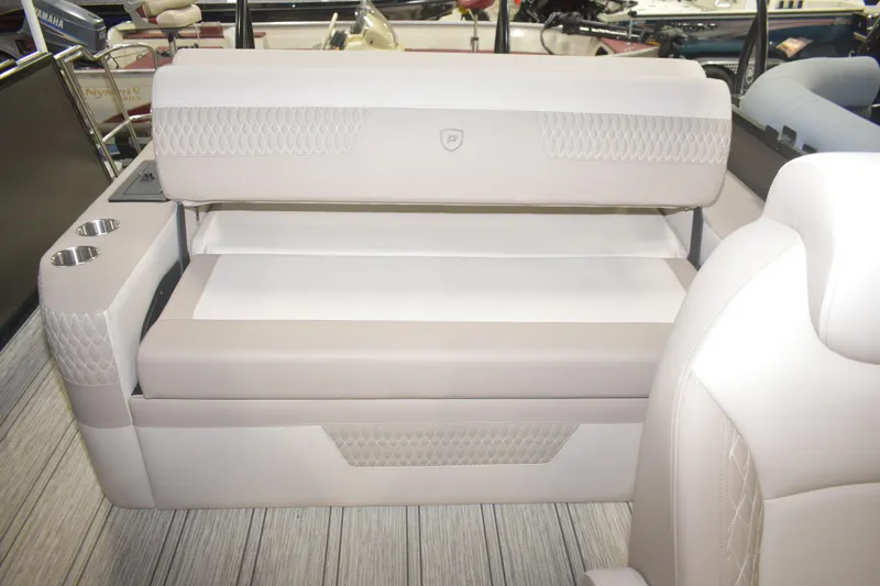 Slide: The Image of 2026 Premier 230 Solaris RL boat interior with plush seating and cup holders. - 13