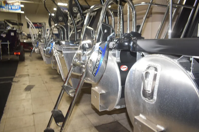 Slide: The Image of 2026 Premier 230 SOLARIS RL - PTX CL pontoon boats with aluminum ladders in showroom. - 19