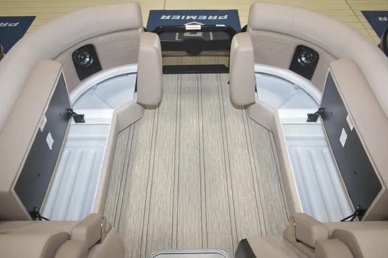 Slide: The Image of 2026 Premier 230 Solaris RL boat interior with open storage compartments and beige seating. - 23