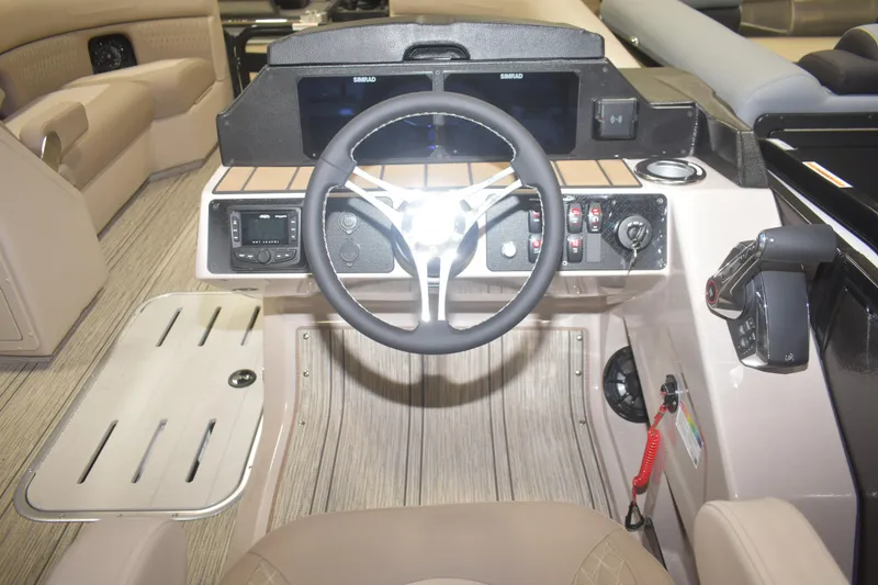 Slide: The Image of Interior cockpit of 2026 Premier 230 Solaris RL boat, featuring steering wheel and control panel. - 9