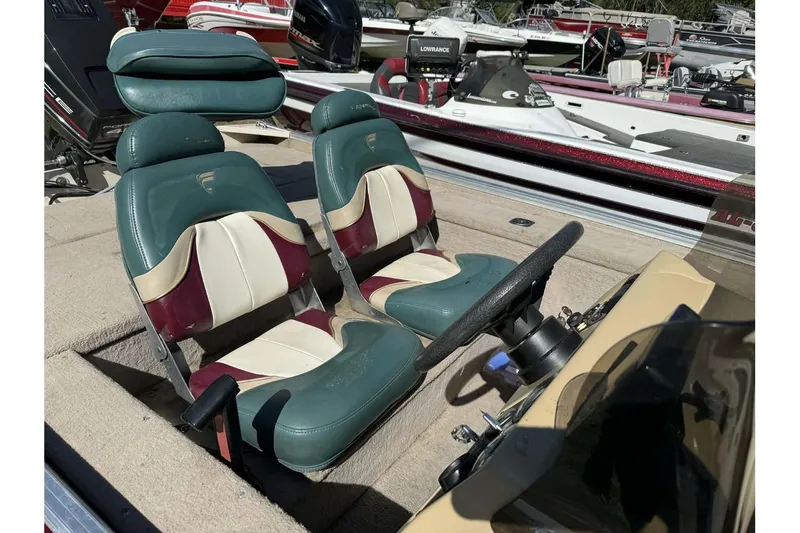 Slide: The Image of 1997 Fisher 1600 boat interior with dual seats and steering wheel, surrounded by other boats. - 12