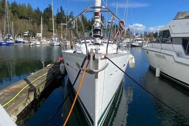 Slide: The Image of 2005 Beneteau Oceanis 373 sailboat docked in a marina, surrounded by other boats. - 1