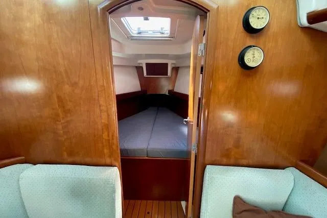 Slide: The Image of Interior of 2005 Beneteau Oceanis 373 sailboat with cozy cabin and wooden finish. - 11
