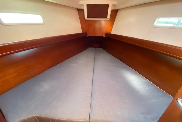 Slide: The Image of Interior cabin of 2005 Beneteau Oceanis 373 sailboat with wooden finish and twin windows. - 12