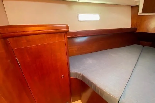 Slide: The Image of 2005 Beneteau Oceanis 373 cabin interior with wooden finish and cozy bed. - 13