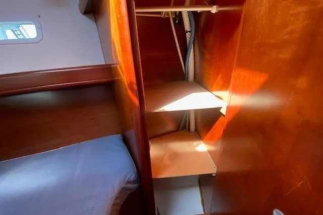 Slide: The Image of Interior cabin of 2005 Beneteau Oceanis 373 sailboat with wooden shelves and bed. - 15