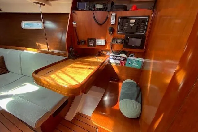 Slide: The Image of Interior of 2005 Beneteau Oceanis 373 sailboat with navigation station and seating area. - 16