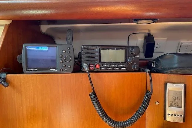 Slide: The Image of Navigation and communication equipment inside a 2005 Beneteau Oceanis 373 sailboat cabin. - 18