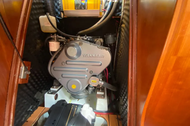 Slide: The Image of Engine compartment of a 2005 Beneteau Oceanis 373 sailboat, featuring a Yanmar engine. - 21
