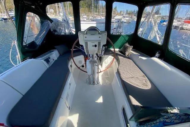 Slide: The Image of Cockpit of 2005 Beneteau Oceanis 373 sailboat with helm and seating, docked in marina. - 29