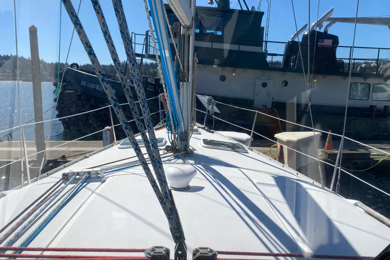 Slide: The Image of 2005 Beneteau Oceanis 373 sailboat docked, with visible rigging and nearby vessel. - 31