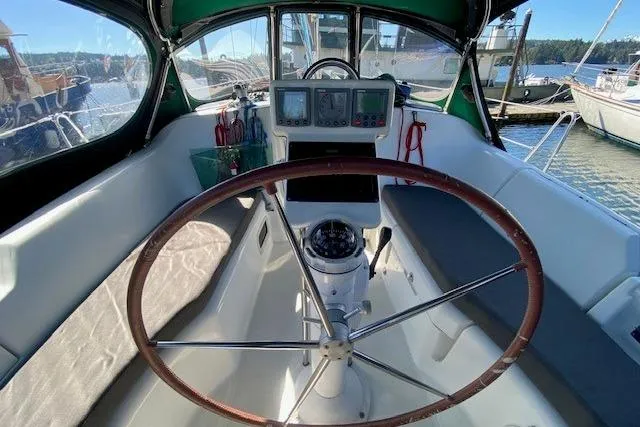 Slide: The Image of Cockpit of 2005 Beneteau Oceanis 373 sailboat with steering wheel and navigation instruments. - 35