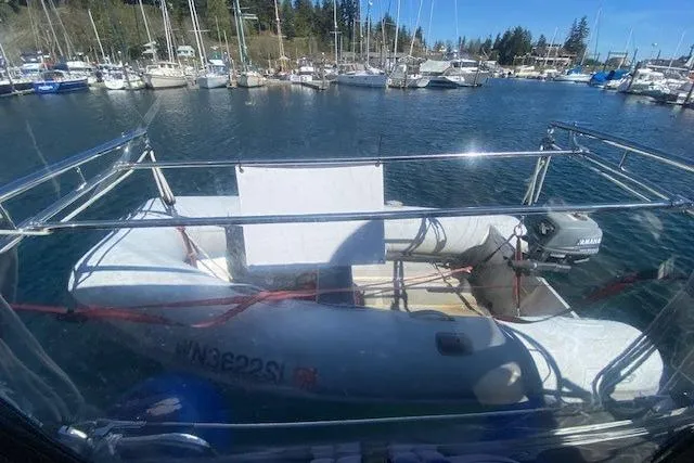 Slide: The Image of A 2005 Beneteau Oceanis 373 with an inflatable dinghy on deck in a marina. - 37