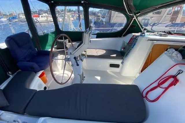 Slide: The Image of Cockpit of 2005 Beneteau Oceanis 373 sailboat with seating and steering wheel. - 38