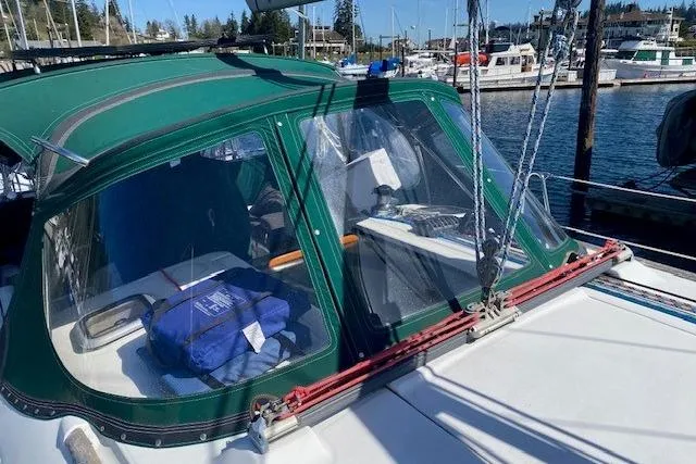 Slide: The Image of 2005 Beneteau Oceanis 373 sailboat with green canopy docked at marina. - 39