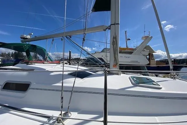 Slide: The Image of 2005 Beneteau Oceanis 373 sailboat docked under clear blue skies. - 4