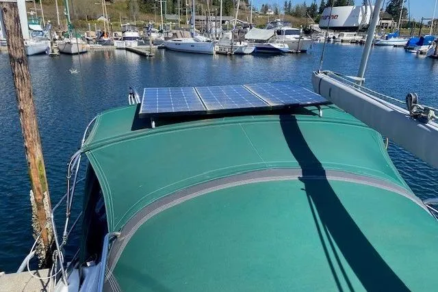 Slide: The Image of Beneteau Oceanis 373 sailboat with solar panels, docked in a marina, 2005 model. - 40