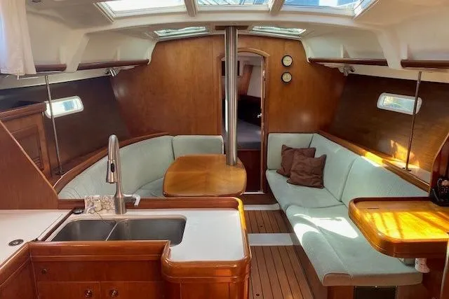 Slide: The Image of Interior of 2005 Beneteau Oceanis 373 sailboat with wood finish and cozy seating area. - 7