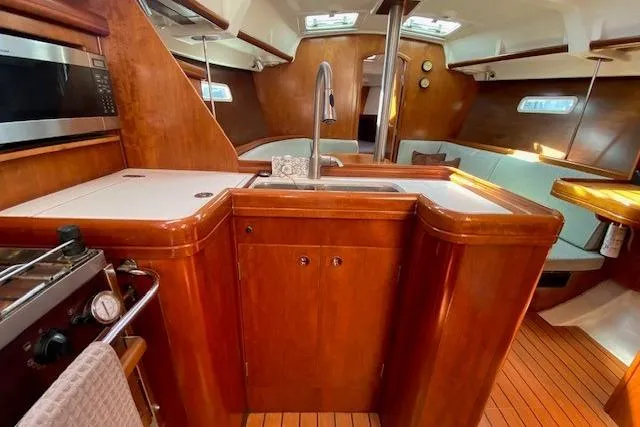 Slide: The Image of Luxurious interior of 2005 Beneteau Oceanis 373 sailboat with wood finish and modern amenities. - 8