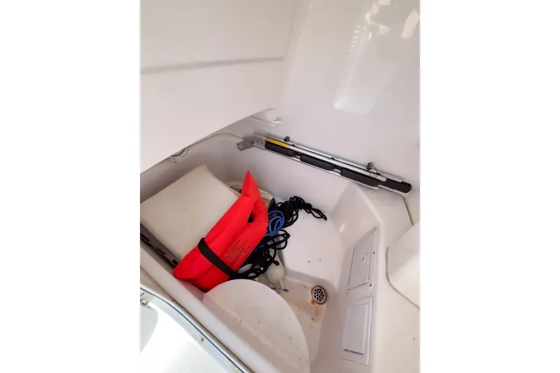 Slide: The Image of Storage compartment of 2013 Everglades 230 Center Console with life jacket and equipment. - 10