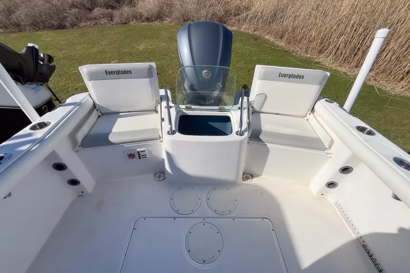 Slide: The Image of 2013 Everglades 230 Center Console boat interior with seating and console view. - 2