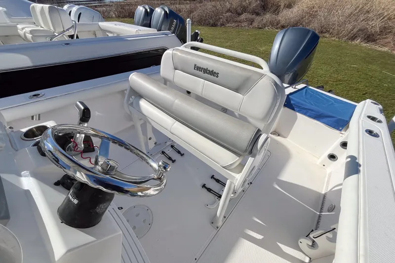 Slide: The Image of 2013 Everglades 230 Center Console boat interior with steering wheel and seating. - 4