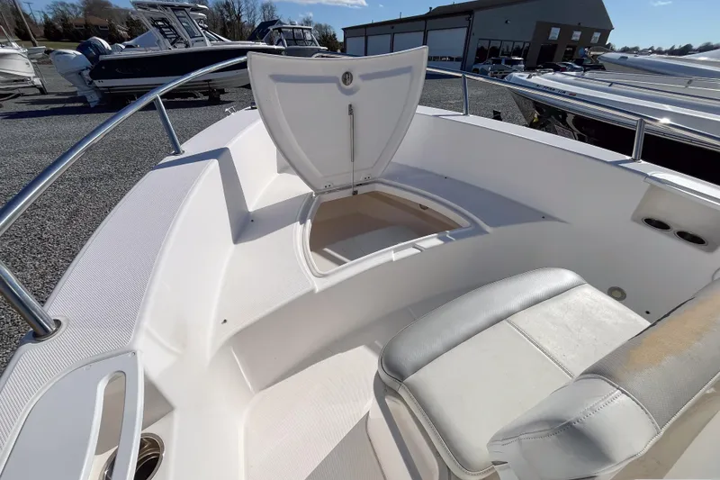 Slide: The Image of 2013 Everglades 230 Center Console boat with open storage compartment and seating. - 8
