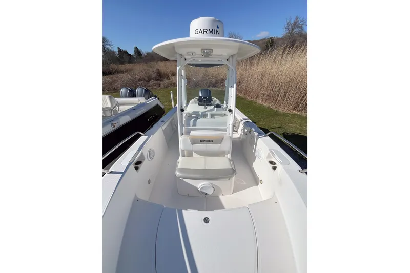 Slide: The Image of 2013 Everglades 230 Center Console boat with Garmin equipment, docked outdoors. - 9