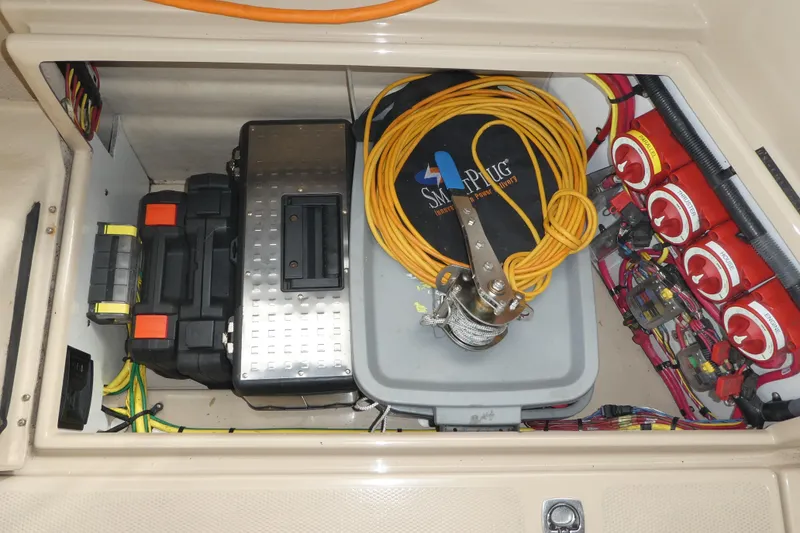 Slide: The Image of 2015 Ranger Tugs R-25 SC engine compartment with wiring, battery, and electrical components. - 20