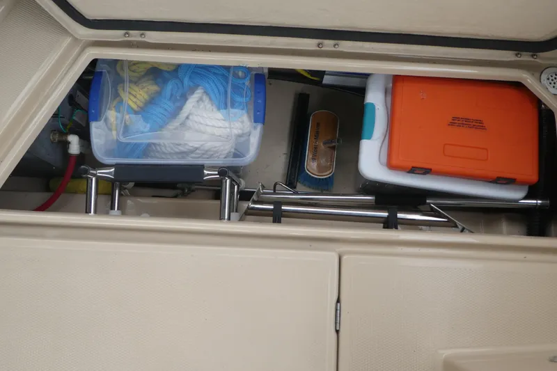Slide: The Image of Storage compartment of 2015 Ranger Tugs R-25 SC with ropes and equipment. - 22