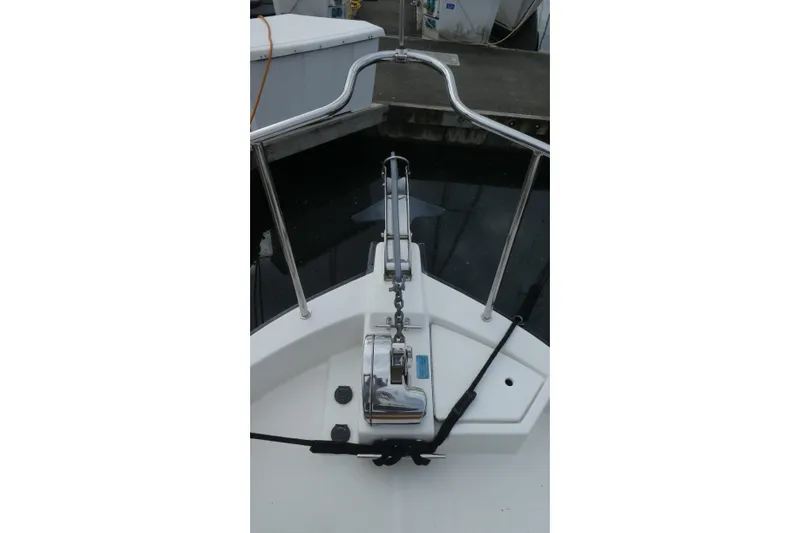 Slide: The Image of 2015 Ranger Tugs R-25 SC boat bow with anchor and railing at dock. - 26