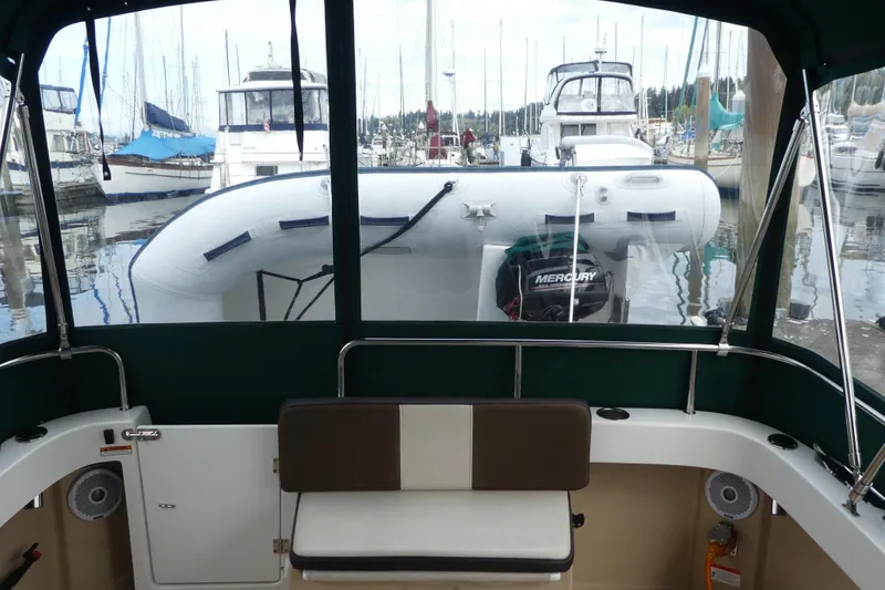 Slide: The Image of 2015 Ranger Tugs R-25 SC interior view with marina backdrop. - 28
