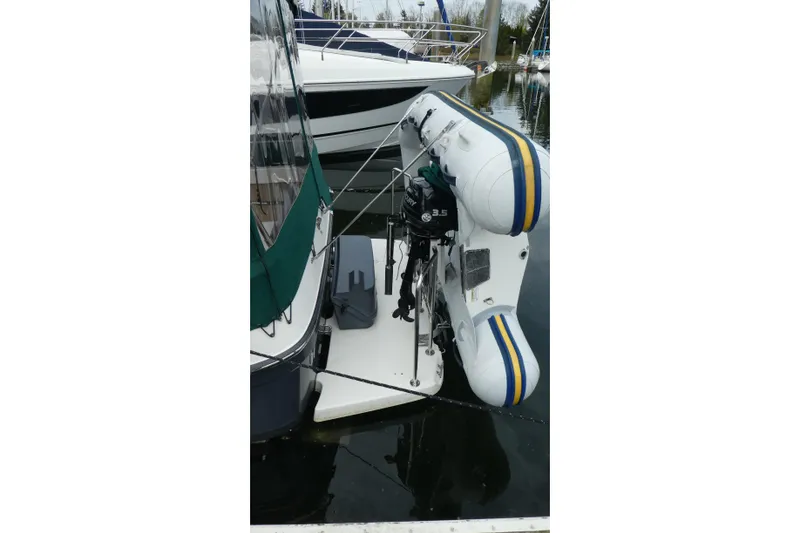 Slide: The Image of 2015 Ranger Tugs R-25 SC with inflatable dinghy and outboard motor at dock. - 29