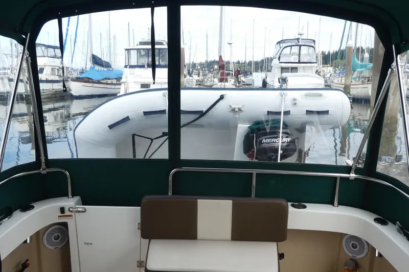 Slide: The Image of Interior view of 2015 Ranger Tugs R-25 SC boat with marina background. - 3