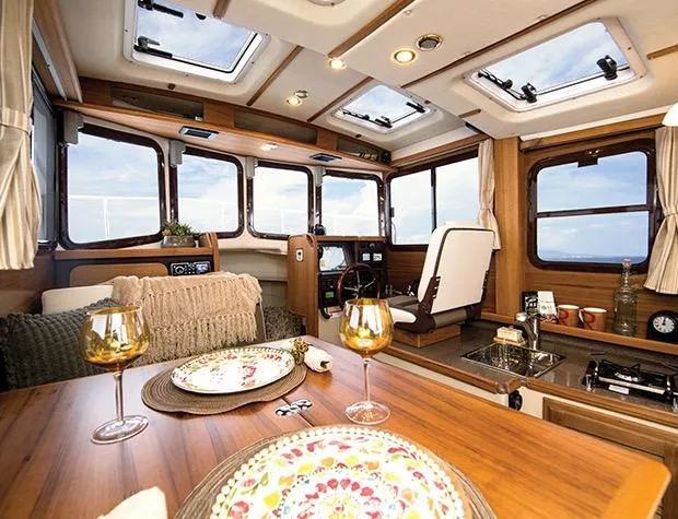 Slide: The Image of Manufacturer Provided Image: Interior of 2015 Ranger Tugs R-25SC boat with dining table and helm station. - 31