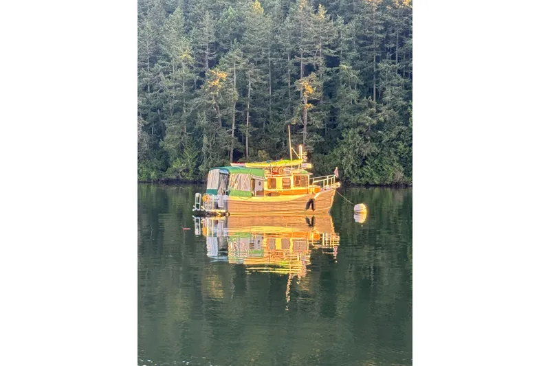 Slide: The Image of 2015 Ranger Tugs R-25 SC boat reflecting on calm forested lake. - 36