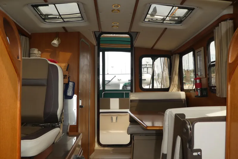 Slide: The Image of Interior of 2015 Ranger Tugs R-25 SC boat with seating and windows. - 9