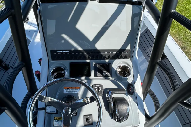 Slide: The Image of 2026 Pathfinder 2500 Hybrid boat console with steering wheel and controls. - 11