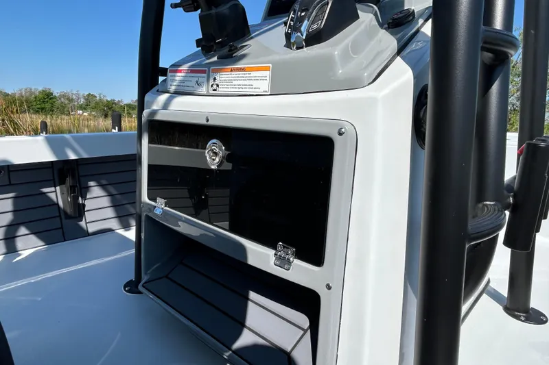 Slide: The Image of 2026 Pathfinder 2500 Hybrid boat console with storage compartment and control panel. - 12
