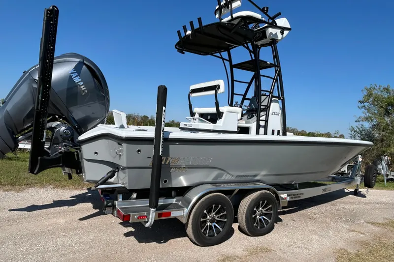 Slide: The Image of 2026 Pathfinder 2500 Hybrid boat on trailer, featuring Yamaha engine, parked outdoors. - 5
