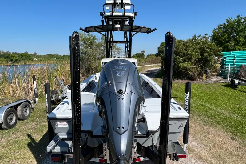 Slide: The Image of 2026 Pathfinder 2500 Hybrid boat with powerful engine, parked near a scenic lake. - 6